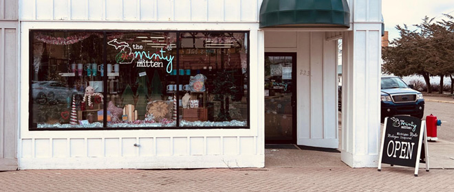 White and black storefront of The Minty Mitten gift shop.
