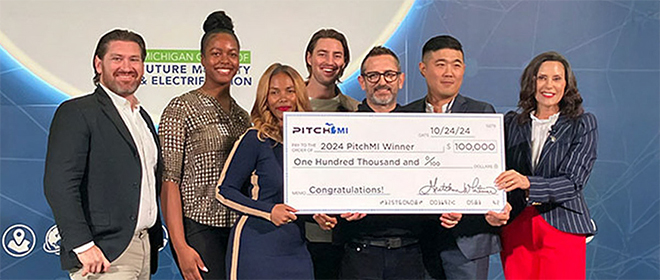 Gov. Gretchen Witmer awards a PitchMI check to a group of winners.